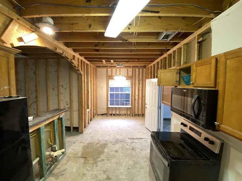 IRS Rebuild crew restoring a kitchen after water damage — full insurance-funded reconstruction in progress